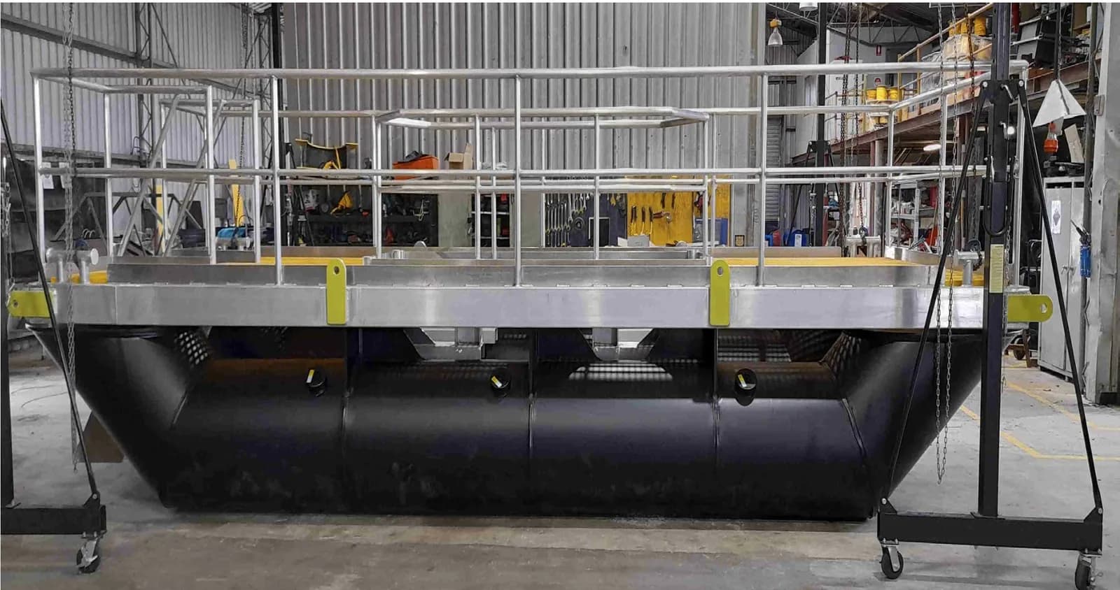 Pump install barge — cylindrical HDPE pontoons and bottom frame beneath the deck