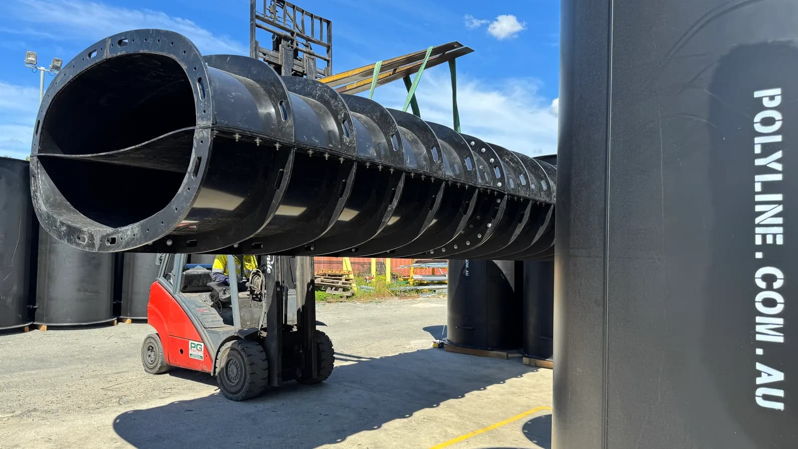 Large-diameter segmented split Polyduct section carried by a forklift