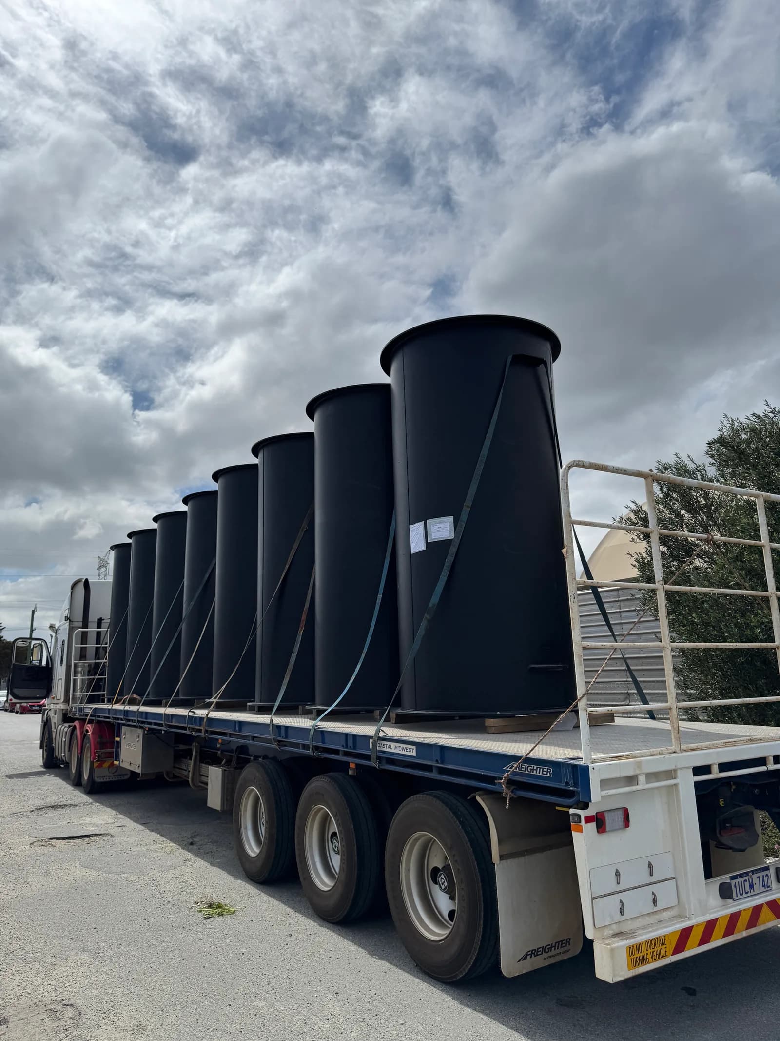 Finished 1,400 mm HDPE duct sections strapped upright on a semi-trailer