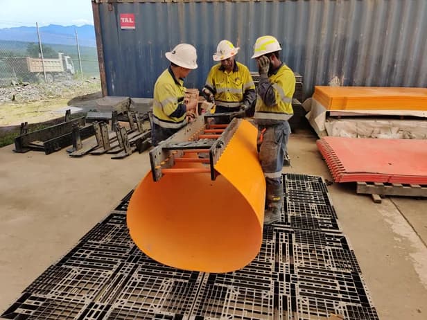 Workers assembling a flat-pack HDPE escapeway section at the yard