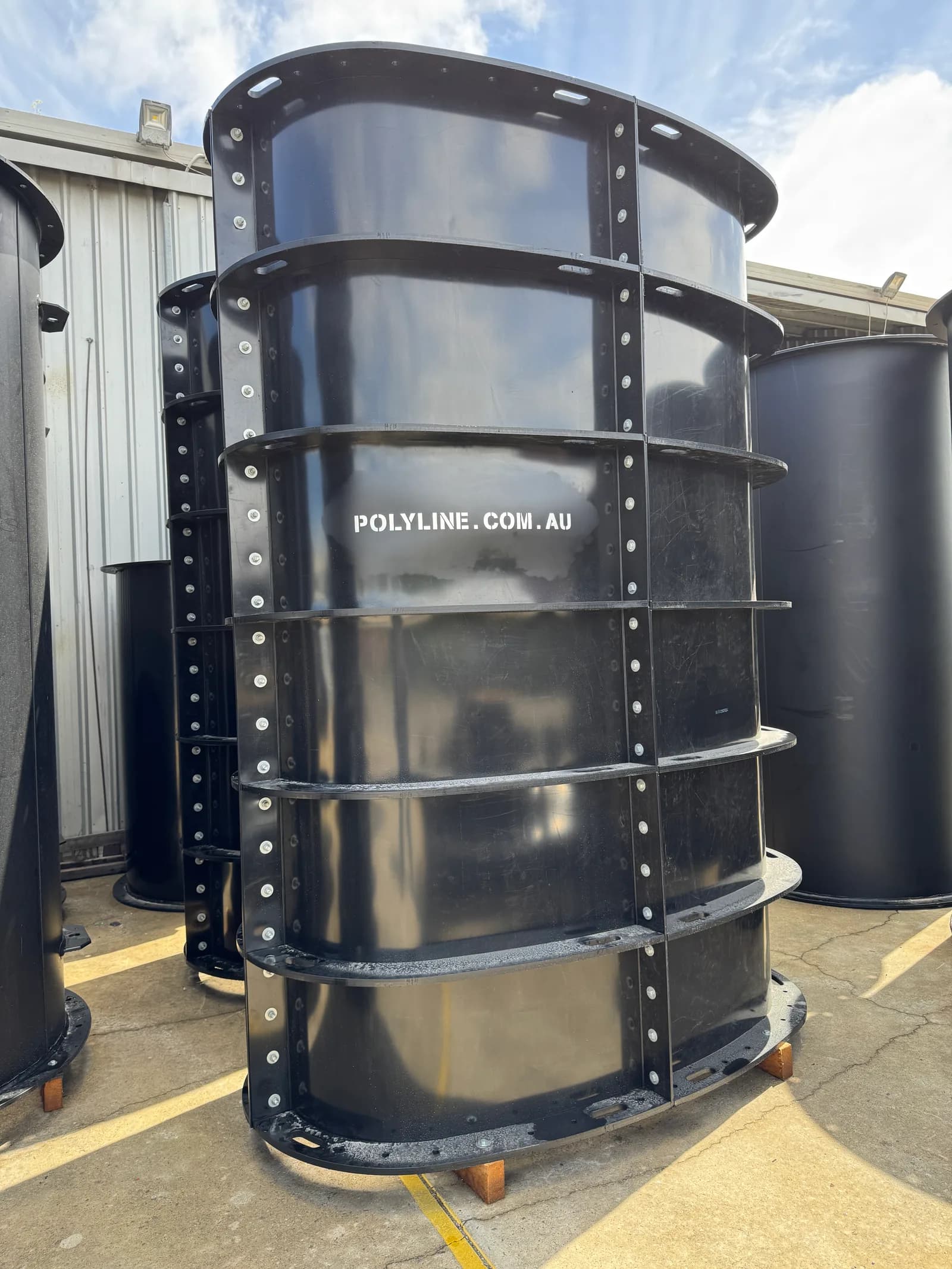 Bolted segmented HDPE duct section standing upright in the yard