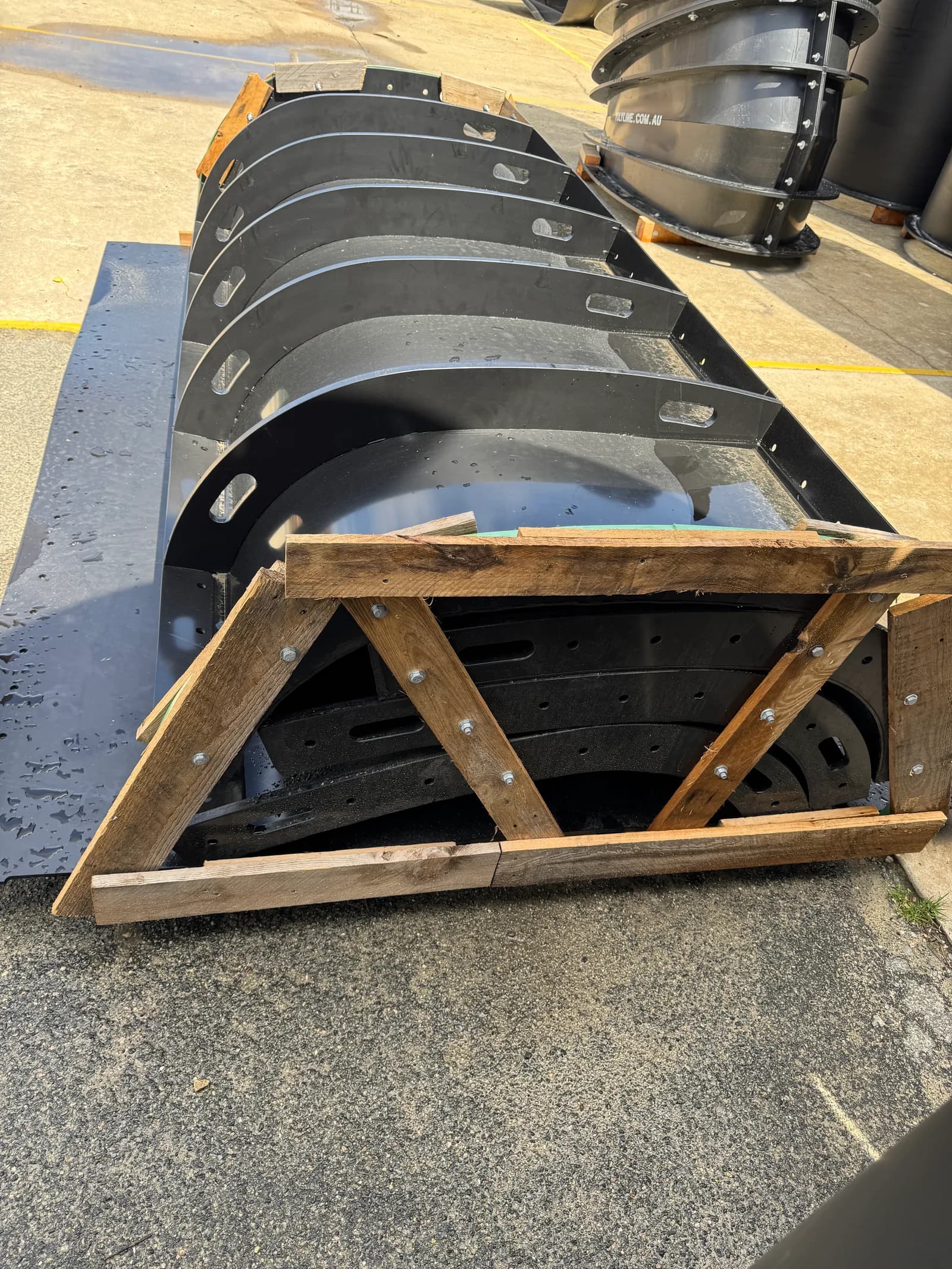 Nested HDPE duct segments stacked in a timber transport frame