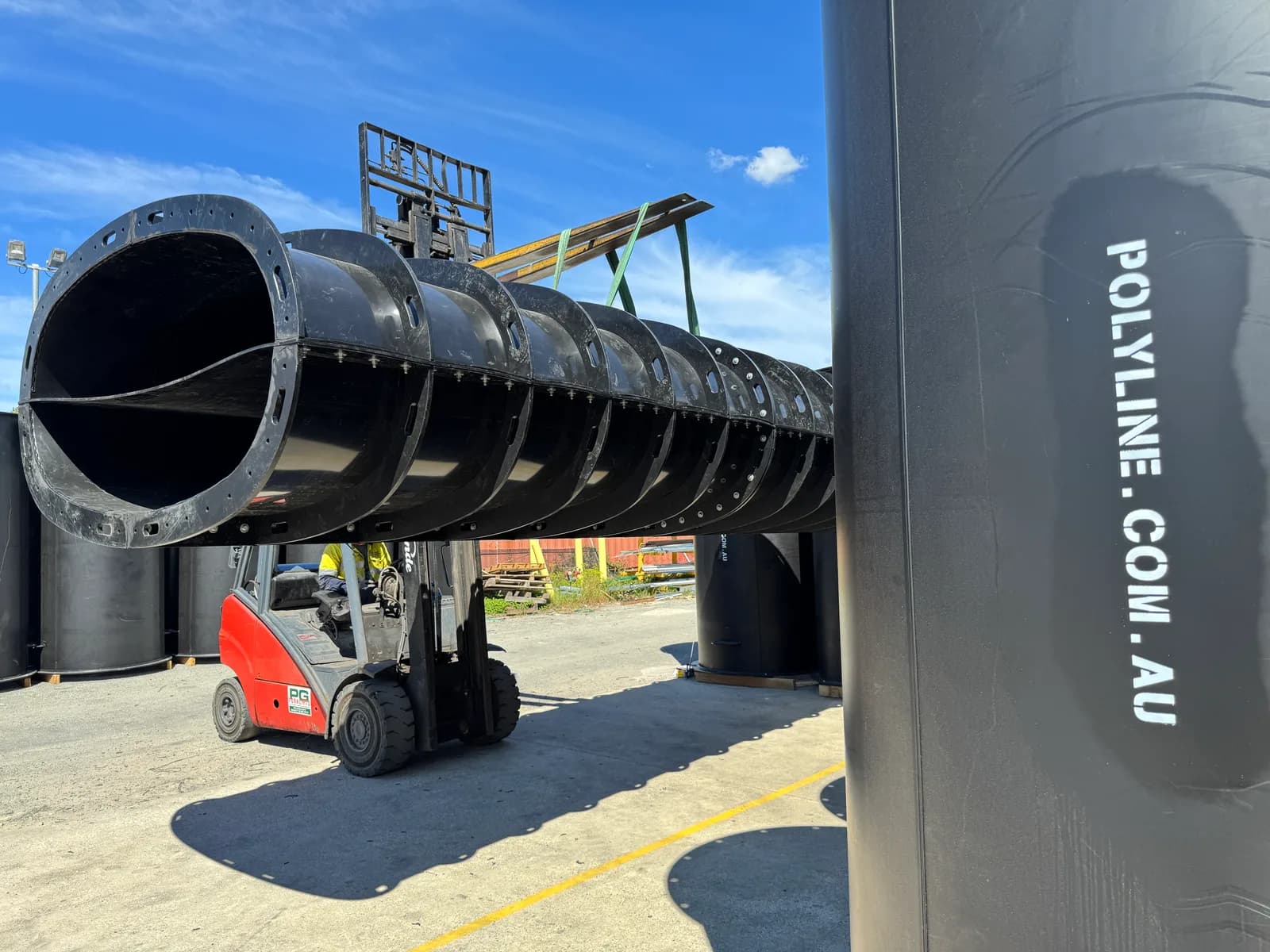 Assembled split Polyduct duct run lifted on a forklift in the Polyline yard