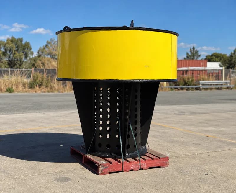 Yellow HDPE pump float with perforated basket on a pallet
