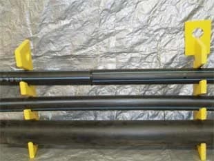 Yellow HDPE service pipe hangers holding three service pipes apart